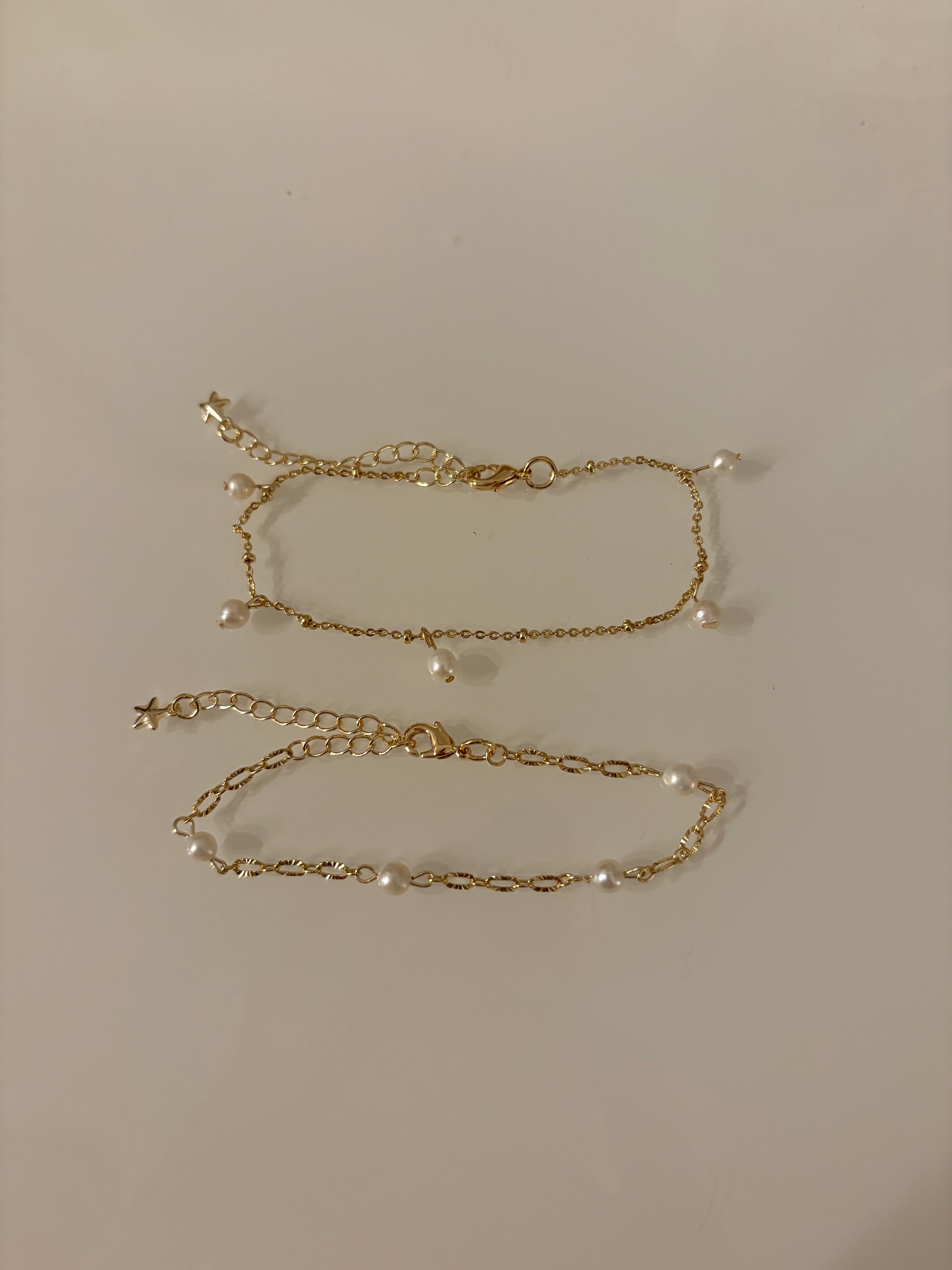 Gold chain necklace on a plain background
